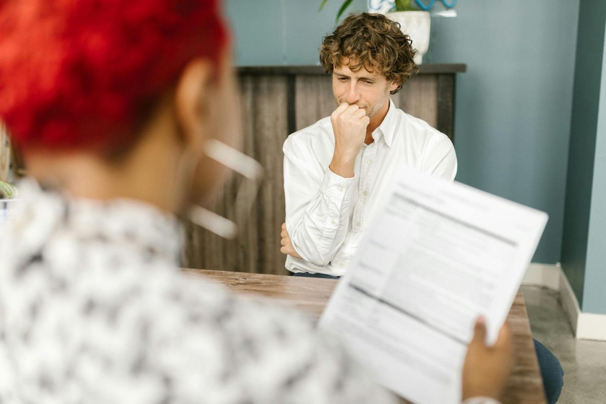 büro man bei vorstellung frau sieht dokument an.jpg
