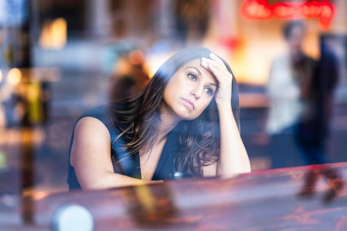 Eine junge Frau sieht deprimiert aus dem Fenster Aktuelle Präventionsforschung zeigt Was uns wi.jpeg